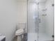 Bathroom featuring toilet and large glass enclosed shower with white and grey tile accents at 4518 Ashmore Dr, Tampa, FL 33610