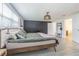 Spacious bedroom offers an ornamental light fixture, a closet, and windows offering natural light at 4518 Ashmore Dr, Tampa, FL 33610