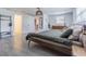Open bedroom with designer light fixture, walk-in closet, wood-style tile floor and natural light from a window at 4518 Ashmore Dr, Tampa, FL 33610