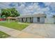 Well-maintained single-story home with lush front lawn, walkway, and fresh paint creating curb appeal at 4518 Ashmore Dr, Tampa, FL 33610