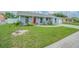 Inviting single-story home features a well-manicured lawn and freshly painted exterior under a sunny sky at 4518 Ashmore Dr, Tampa, FL 33610