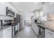 Bright kitchen featuring granite countertops, stainless steel appliances, and subway tile backsplash at 4518 Ashmore Dr, Tampa, FL 33610