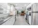 Modern kitchen featuring stainless steel appliances, granite countertops and seamless transition to the living area at 4518 Ashmore Dr, Tampa, FL 33610