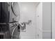 Laundry room featuring a gray stacked washer and dryer, and a white linen closet for storage at 4518 Ashmore Dr, Tampa, FL 33610