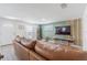 Inviting living room with a comfortable brown leather couch and stylish green accent wall with modern decor at 4518 Ashmore Dr, Tampa, FL 33610