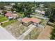 Aerial shot of a beautiful home with fenced in yard, landscaping, and paved driveway at 525 38Th S St, St Petersburg, FL 33711