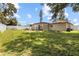 A green backyard with grass, a fence, and some furniture at 525 38Th S St, St Petersburg, FL 33711