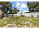 A backyard with grass, a white fence, and a small deck at 525 38Th S St, St Petersburg, FL 33711