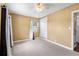 A cozy bedroom with neutral carpet, fan, window and closet at 525 38Th S St, St Petersburg, FL 33711