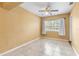 Bright bedroom featuring a ceiling fan, tile floors, and a window providing natural light at 525 38Th S St, St Petersburg, FL 33711