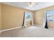 A bright bedroom with neutral carpet, curtains, baseboards, and two windows at 525 38Th S St, St Petersburg, FL 33711
