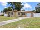 Charming single-story home showcasing a well-manicured lawn, a concrete driveway, and a secure fenced-in yard at 525 38Th S St, St Petersburg, FL 33711