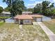 Aerial view of a charming, fenced-in single Gathering home surrounded by lush trees, blue skies and a paved driveway at 525 38Th S St, St Petersburg, FL 33711
