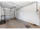 View of the attached garage featuring a lawnmower, concrete flooring, and a door with an automatic opener at 525 38Th S St, St Petersburg, FL 33711