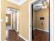 Hallway view showcasing the layout of the home with multiple doorways and wood flooring at 525 38Th S St, St Petersburg, FL 33711