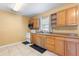 Functional kitchen featuring wooden cabinets, essential appliances, and a window for natural light at 525 38Th S St, St Petersburg, FL 33711