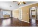 Bright living room featuring wood flooring, a ceiling fan, and a large window at 525 38Th S St, St Petersburg, FL 33711