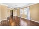 Bright living room with wood floors, fan, and a large window, offering lots of natural light at 525 38Th S St, St Petersburg, FL 33711