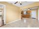 Open living space showcasing tile flooring, a view into the kitchen, and ample natural light at 525 38Th S St, St Petersburg, FL 33711