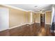 Spacious living room featuring wood flooring, a ceiling fan, and a built in shelving unit at 525 38Th S St, St Petersburg, FL 33711