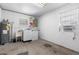Utility room with water heater, sink, washer, dryer and window air conditioner at 525 38Th S St, St Petersburg, FL 33711