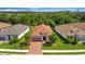 Aerial view of a home with a red tile roof, lush landscaping, and a paved driveway at 5320 Morey Farms Loop, Palmetto, FL 34221
