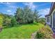 Lush green backyard with well-maintained landscaping and mature trees, perfect for outdoor enjoyment at 5320 Morey Farms Loop, Palmetto, FL 34221