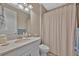 Bright bathroom featuring a single vanity, a stylish sink, and a shower with curtain at 5320 Morey Farms Loop, Palmetto, FL 34221