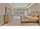 Spacious bedroom with tray ceilings, carpet, and a large bay window that offers great natural light at 5320 Morey Farms Loop, Palmetto, FL 34221