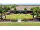 Rear shot of clubhouse, featuring cornhole, and expansive green lawn at 5320 Morey Farms Loop, Palmetto, FL 34221