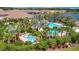 Resort-style community pool and spa with palm trees, lounge chairs, and lush landscaping at 5320 Morey Farms Loop, Palmetto, FL 34221