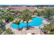 Resort-style community pool with palm trees, lounge chairs, and lush landscaping, perfect for relaxation and recreation at 5320 Morey Farms Loop, Palmetto, FL 34221