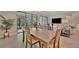 Open-concept dining and living area with sliding glass doors to an outdoor space at 5320 Morey Farms Loop, Palmetto, FL 34221
