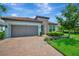 Charming single-story home with tile roof, brick driveway, manicured landscaping, and well-maintained lawn at 5320 Morey Farms Loop, Palmetto, FL 34221