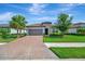 Charming single-story home with tile roof, brick driveway, landscaped lawn, and meticulous curb appeal at 5320 Morey Farms Loop, Palmetto, FL 34221