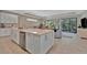 Open kitchen featuring a large island with seating, stainless steel appliances, and a modern design at 5320 Morey Farms Loop, Palmetto, FL 34221