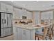 Modern kitchen featuring stainless steel appliances, a large island, and barstool seating at 5320 Morey Farms Loop, Palmetto, FL 34221