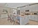 Bright kitchen featuring white cabinets, stainless steel appliances, and seating around the island at 5320 Morey Farms Loop, Palmetto, FL 34221