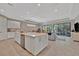 Open-concept kitchen with white cabinets, stainless steel appliances, and a large island at 5320 Morey Farms Loop, Palmetto, FL 34221