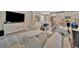 Comfortable living room featuring a large TV, modern furniture, and an open floor plan to the kitchen at 5320 Morey Farms Loop, Palmetto, FL 34221