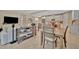 Bright open-concept living room and kitchen area features modern furniture and lots of natural light from the entryway at 5320 Morey Farms Loop, Palmetto, FL 34221