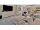 Bright living room features a modern entertainment center and comfortable seating perfect for relaxing and entertaining guests at 5320 Morey Farms Loop, Palmetto, FL 34221