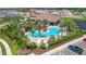 Resort-style pool and clubhouse surrounded by lush landscaping and palm trees in a beautiful community at 5320 Morey Farms Loop, Palmetto, FL 34221