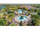 Aerial view of community pools with mature landscaping, poolside seating, and nearby clubhouse at 5320 Morey Farms Loop, Palmetto, FL 34221