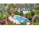 Relaxing spa with clear blue water, stone surroundings, and palm trees, perfect for unwinding and enjoying the scenery at 5320 Morey Farms Loop, Palmetto, FL 34221