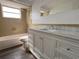 Classic bathroom featuring a white vanity with a marble countertop and a tiled shower and tub combo at 5507 Casino Dr, Holiday, FL 34690