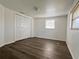 Comfortable bedroom with wood-look floors, closet space, and windows for natural light at 5507 Casino Dr, Holiday, FL 34690
