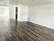 Spacious living room featuring modern wood-look floors and a neutral color palette at 5507 Casino Dr, Holiday, FL 34690