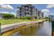 Exterior of a waterfront condo building with a swing set and tropical landscaping at 5722 Biscayne Ct # 107, New Port Richey, FL 34652