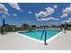 Inviting community pool with lounge chairs and clear blue skies, perfect for relaxation at 5722 Biscayne Ct # 107, New Port Richey, FL 34652